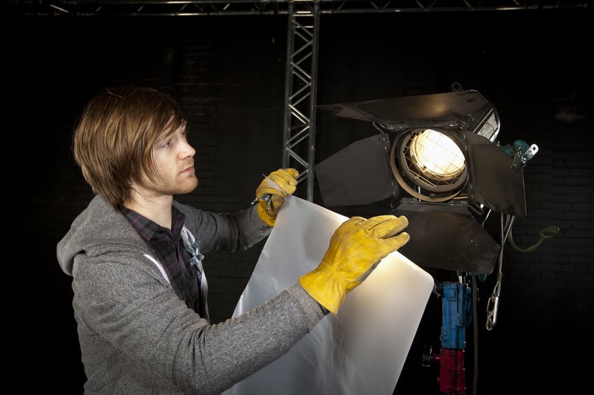 Best Boy Grip adjusting lighting on set