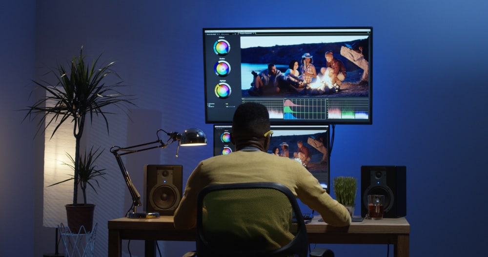 Film editor working on continuity editing on his computer