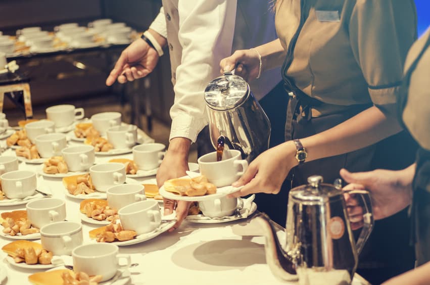 Film catering team members pouring coffee and setting out slices of pie