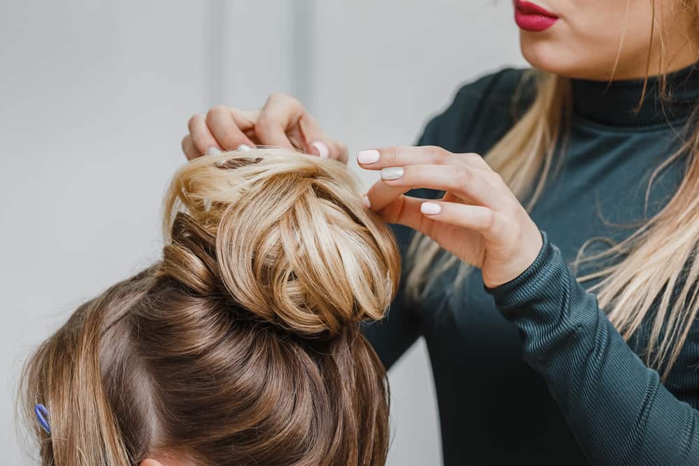 Hairdresser fixing an actress' hair
