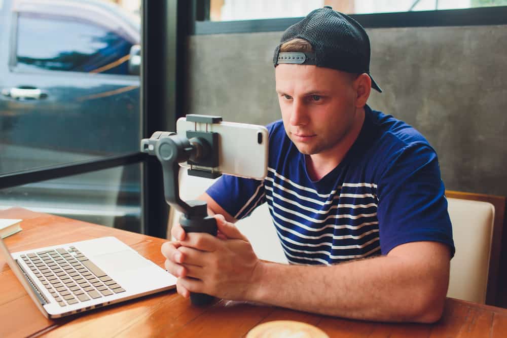 Young man making a movie on his iPhone