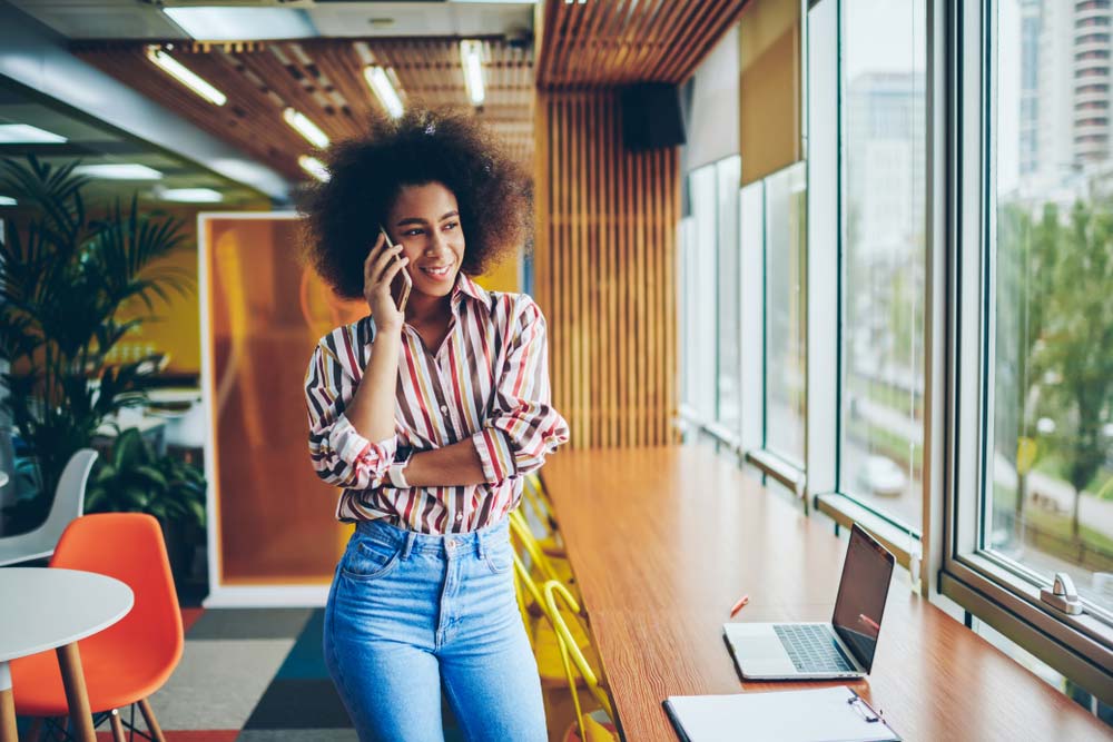 Post-production Coordinator talking on her phone at her office