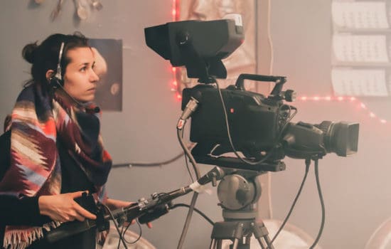 Camera operator using camera on set