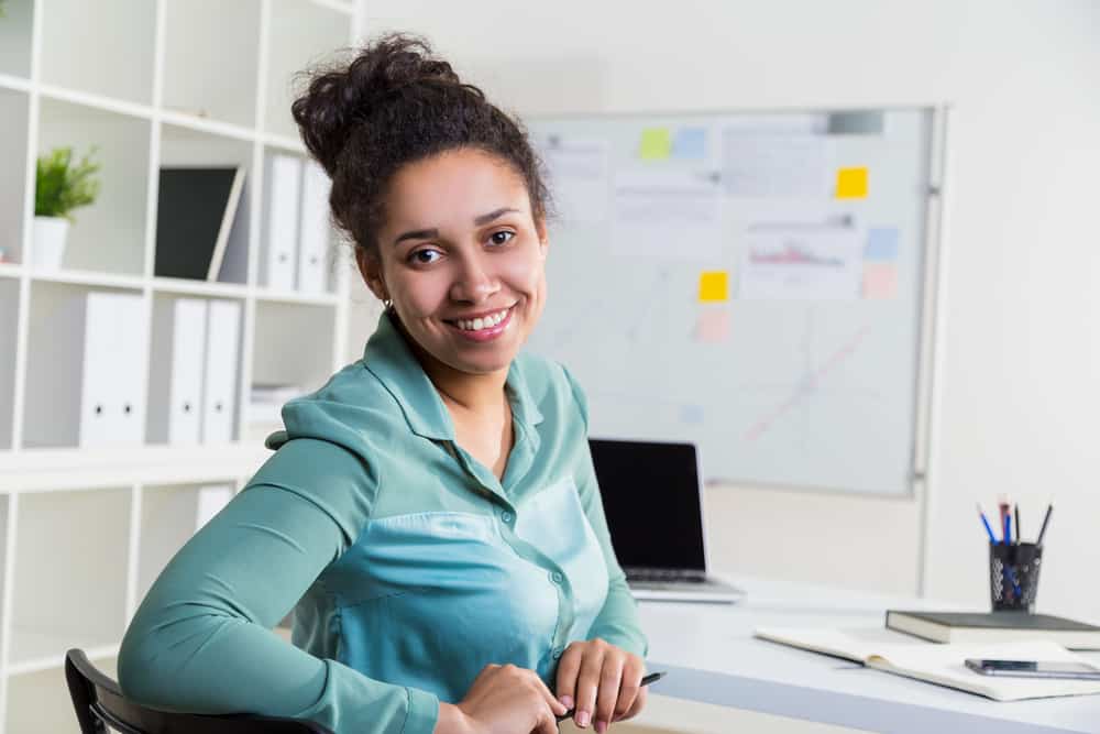 Female production coordinator sitting in her office